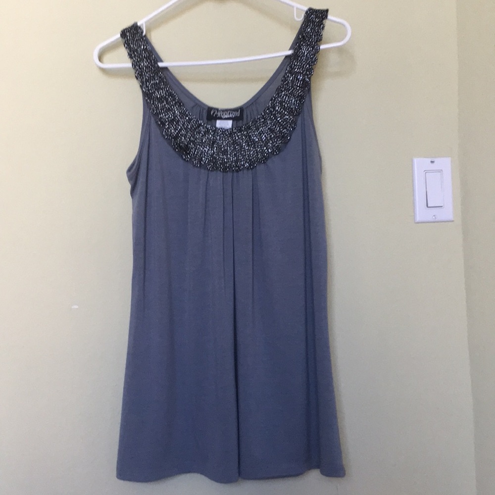 Sleeveless top with embroidered front.